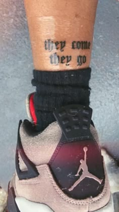 a person with a tattoo on their leg wearing sneakers and socks that say, they come very no