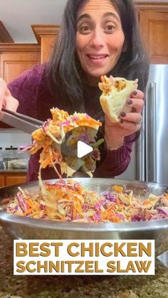 the woman is eating her chicken shawl in front of the kitchen counter with text overlay that reads best chicken schnitzel slaw