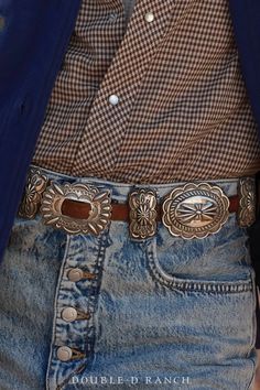 A CLASSIC CONCHO BELT IS A SOUTHWESTERN STAPLE. How stunning is this contemporary concho belt? The slender leather strap is adorned with 7 classic sterling silver scallop conchos alternated by 8 butterfly concho spacers, and finished with a complementing concho frame buckle. Timeless and classic – a must-have for every cowgirl’s closet. materials: sterling silver, leather strap dimensions on buckle 2 1/2" 7 conchos at 2 1/2" x 2 1/4" 8 butterfly spacers 2" x 1" belt fits 32" weight: 416 grams ni Concho Leather Belt, Classic Antique Belt Buckles For Ranch, Classic Concho Belt Buckles For Rodeo, Classic Concho Belt Buckles, Elegant Leather Concho Belt, Classic Belt Buckles For Western-themed Events With Belt, Classic Concho Belt For Western-themed Events, Western Silver Embroidered Belt, Formal Adjustable Concho Belt