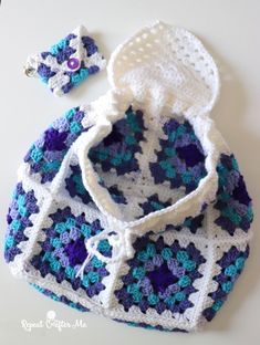 a crocheted bag and hat sitting on top of a table