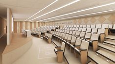 an empty lecture hall with rows of chairs in the front and back seats on the side