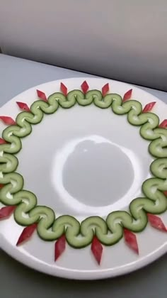 a person decorating a plate with green and red decorations