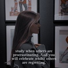 a woman standing in front of pictures with an inspirational quote on the wall behind her