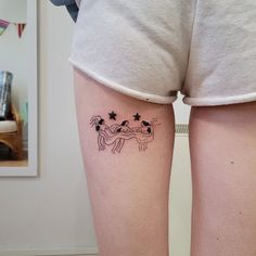 a woman's legs with tattoos on them and stars in the shape of horses