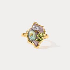 Elevate your jewelry collection with the enchanting allure of our Purple Pearl Tulip Flower Ring. This exquisite piece captures the delicate beauty of nature with its intricately crafted tulip flower design, accentuated by lustrous pearls set against a backdrop of rich, deep purple enamel. Crafted from 18K gold-plated brass, this ring exudes luxury and sophistication, making it a timeless accessory that adds a touch of elegance to any ensemble. Its unique design and vibrant color palette make it Exquisite Yellow Gold Flower Ring As Gift, Exquisite Yellow Gold Flower Ring For Gift, Delicate Gold Flower Ring With Gemstone, Gold Flower Ring Nature-inspired, Gold Flower-shaped Nature-inspired Rings, Elegant Petal Shaped Rings For Gift, Gold Nature-inspired Flower Ring, Nature-inspired Gold Flower Ring, Elegant Birth Flower Jewelry Ring