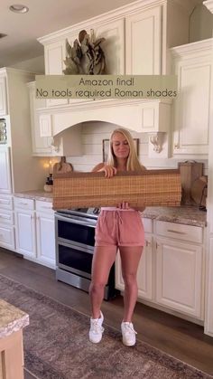 a woman standing in front of a kitchen holding a large wooden box with the words amazon find no tools required human shoes