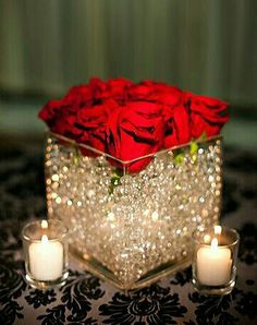 red roses in a crystal box with candles