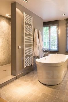 a bathroom with a large tub and shower