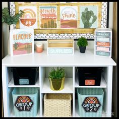 a shelf with some plants and other items on it in front of a bulletin board