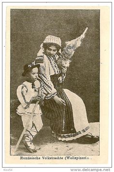 an old black and white photo of two children dressed in native american clothing, one holding a bird