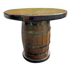 an old wooden barrel table with a glass top