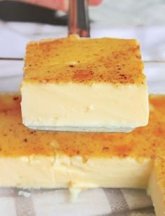 two pieces of cake sitting on top of a plate next to a person holding a knife