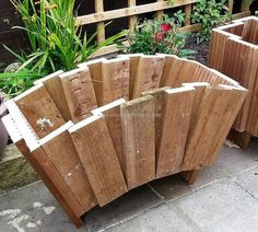 two wooden planters sitting next to each other in front of a fenced area