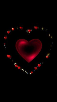 a red heart surrounded by small hearts and sparkles on a black background with stars