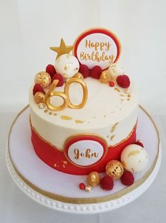 a white and red cake with gold decorations on it's top is sitting on a plate