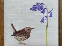 An original framed embroidered picture of a Wren and Bluebell. Machine embroidery on pale silver linen fabric with metallic silver embroidery detail.  Embroidery size 7x7 inches.  Framed without glass.  Wooden frame stained and waxed in med oak. From a distance these pictures may look like paintings but on closer inspection you can see the texture of the stitches and the play of light and shadow on the thread. It is this beautiful reflection of light, and the way the colours change, that makes t Detail Embroidery, Stump Work, Embroidered Animals, Fabric Postcards, Silver Embroidery, Yorkshire Dales, Art Textile, Art Handmade, Embroidery Inspiration