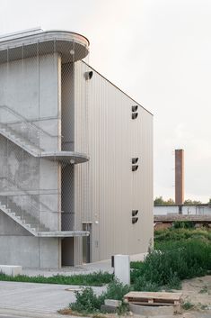 the building is made out of concrete and has a spiral staircase leading up to it