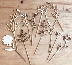 wooden cutout flowers sitting on top of a table