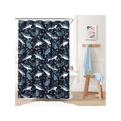 a shower curtain with blue and white animals on it in a bathroom next to a wooden stool