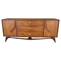 an art deco sideboard with three drawers