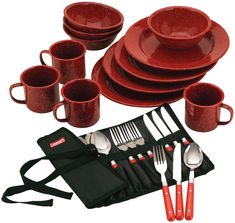 a red dinnerware set with silverware and utensils is shown in this image