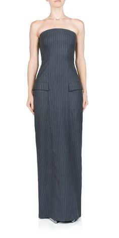 Made from a luxurious pinstripe wool blend fabric, the BEC + BRIDGE Pine Strapless Maxi Dress provides a sleek and flattering silhouette. Accented with front flap pockets and side slit pockets, it features a straight strapless neckline and back vent, fitted at the waist before falling into a straight skirt. ﻿Details: Color: Charcoal Pinstripe Main: 40% wool, 29% polyester, 28 viscose, 3% spandex. Pocketing: 100% polyester Zip closure at back Side seam pockets Intended for a very close fit; those Bridge Dress, Coffee Sweater, Skirt Details, Modern Design Elements, Bec Bridge, Suit Dress, Strapless Neckline, Strapless Maxi, Work Dresses