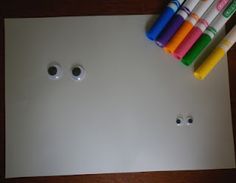 several different colored crayons sitting on top of a white surface with holes in the middle