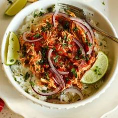 a bowl filled with rice, onions and cilantro on top of a table