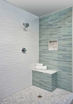 a bathroom with a glass tile shower wall