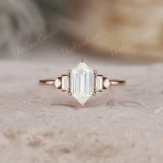 an emerald cut diamond ring with three side stones