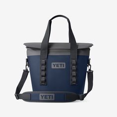 the yeti cooler bag is shown in blue and grey with an adjustable shoulder strap