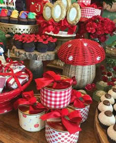 a table topped with lots of cupcakes and cakes