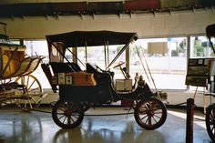 an old fashioned car is parked in a garage