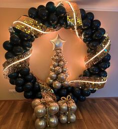 a christmas tree made out of black and gold balloons