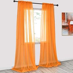 an orange curtain hanging in front of a window