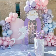 a mermaid themed birthday party with balloons and decorations