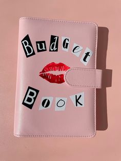 a pink book with the words budget book written on it and a red lipstick imprint