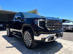 a large black truck parked in a parking lot