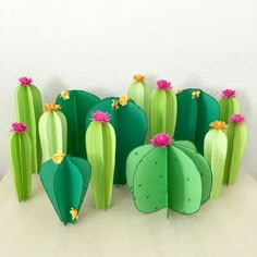 paper flowers are arranged in the shape of cactuses