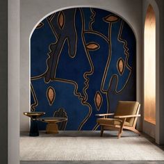 a chair and table in front of a wall with an abstract painting on it's side