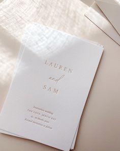 the wedding stationery is laid out on a table