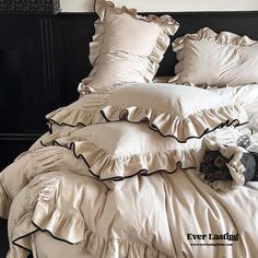 an unmade bed with ruffled sheets and pillows