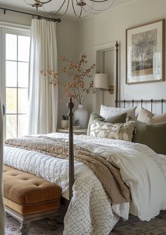 a bedroom with a large bed and a chandelier hanging from the ceiling above it