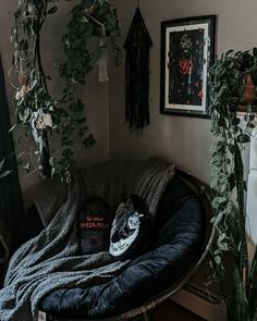 a cat sleeping on top of a pet bed in a living room next to a potted plant