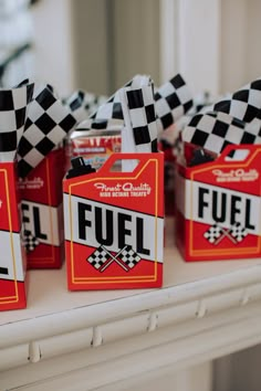 small boxes with fuel labels on them sitting on a mantle