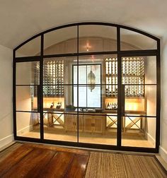 the inside of a wine cellar with glass doors