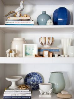 shelves with vases, books and other items on them