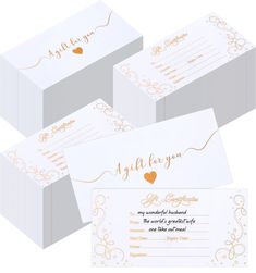 three white boxes with gold foil lettering and hearts on the front, two are empty