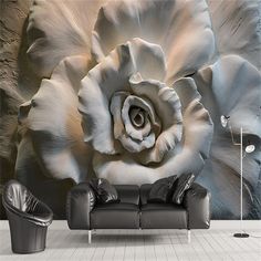 a living room with a couch and large flower wall mural