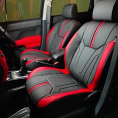 the interior of a car with black and red seats